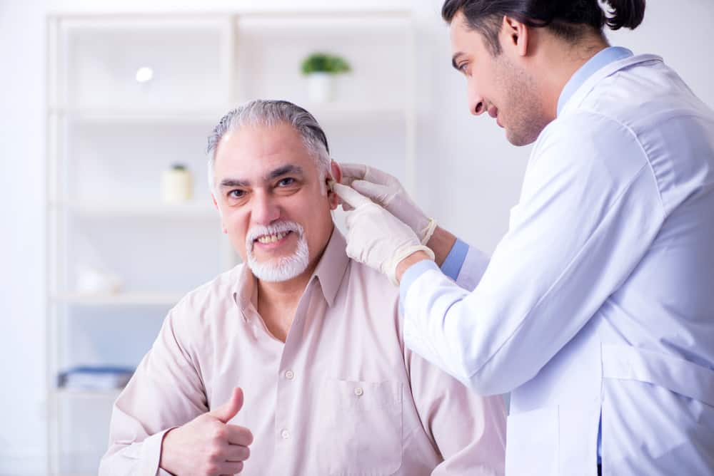 Male patient with hearing problem visiting doctor